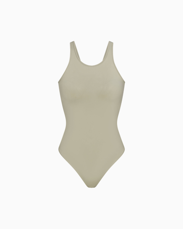 A MODEL POSES WEARING SKIMS CLOTHING