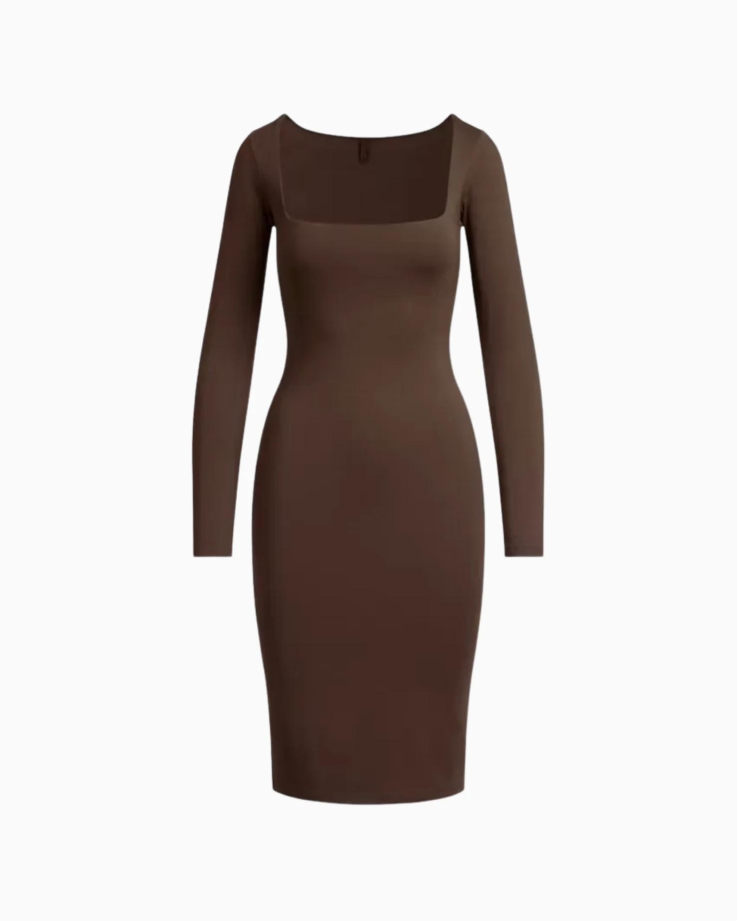 A MODEL POSES WEARING SKIMS SHORTS