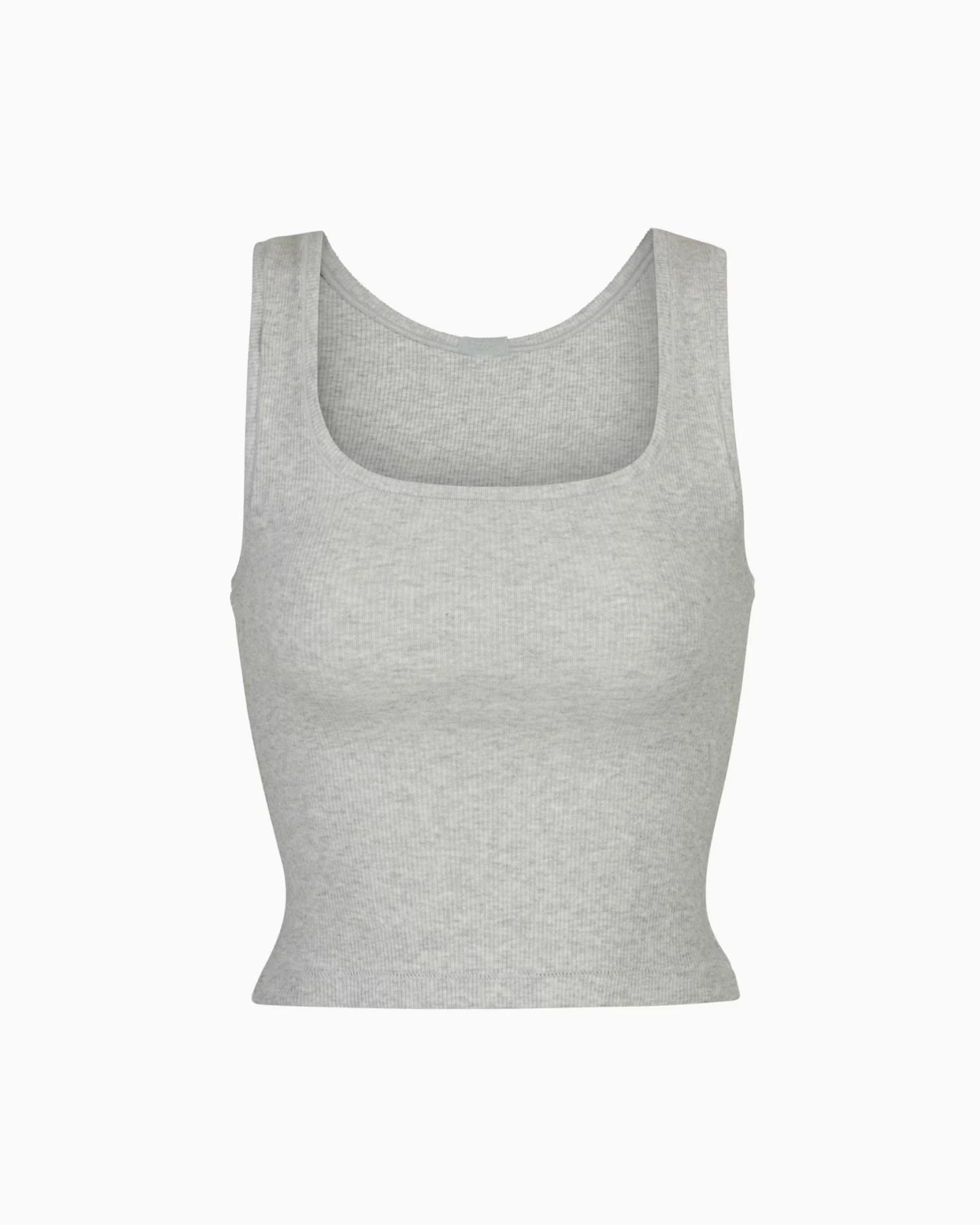 A MODEL POSES WEARING SKIMS COTTON RIB TANK